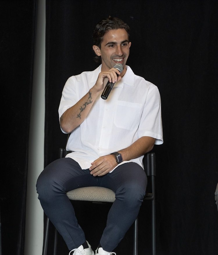 Luca on stage with a microphone.